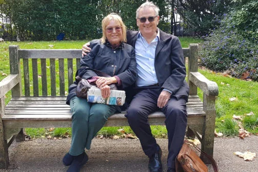 Phoebe and Tony Hall sit on a bench in Lincoln Inn Fields
