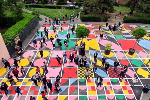 People stood on a colourful tiled floor in Milan