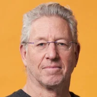 A headshot of Professor Ehud Shapiro against an orange background