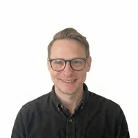 headshot of a man with glasses