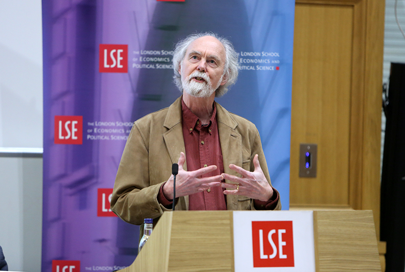 Barry Buzan speaking from LSE lectern with LSE banner in background