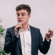 Chris Thomas speaks into a microphone