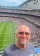 Glyn Robbins at Twickenham stadium, a full stadium can be seen below him.