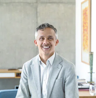 Headhshot of Kieron Boyle in a blazer and shirt