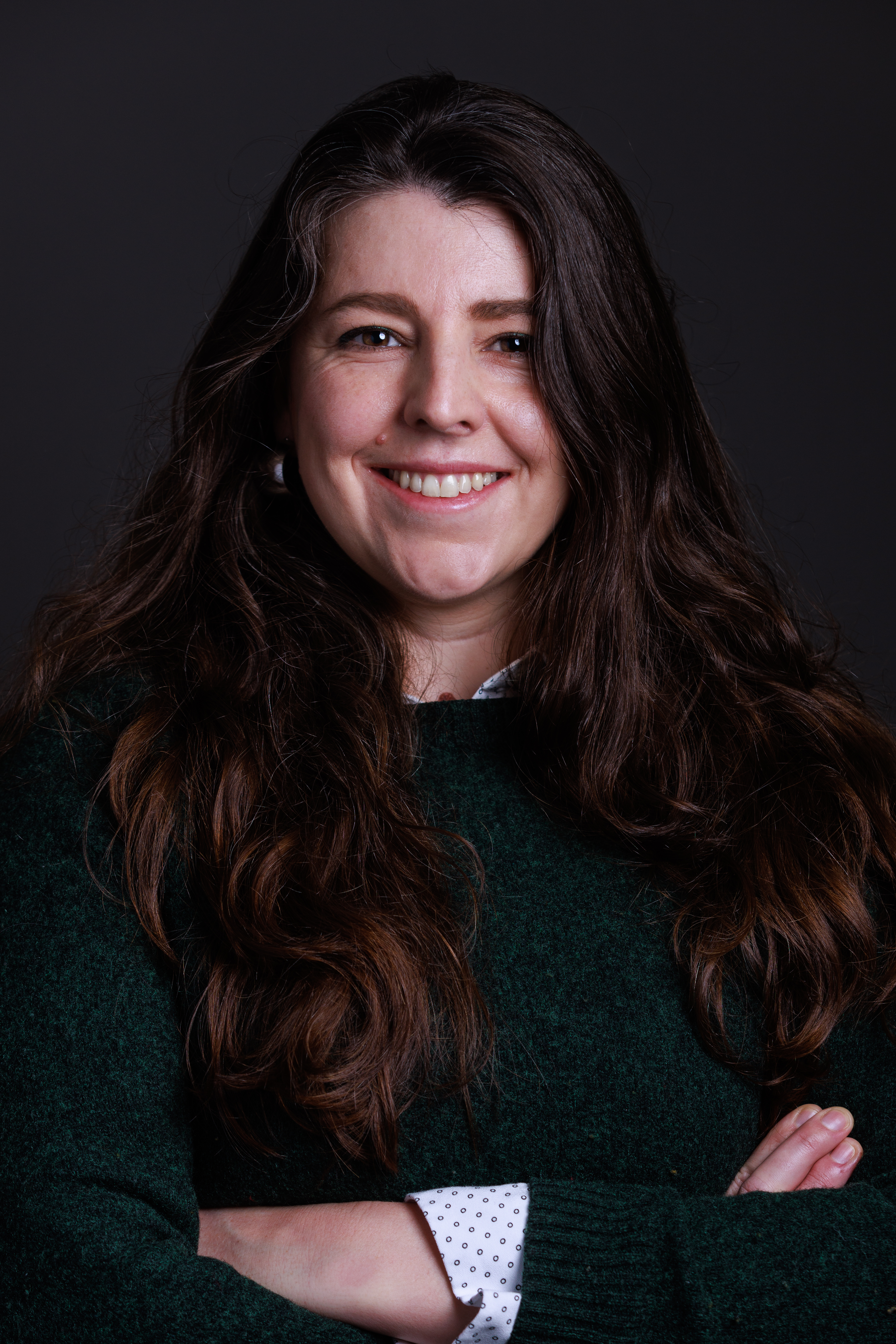 Lucy Garbett smiling with arms folded