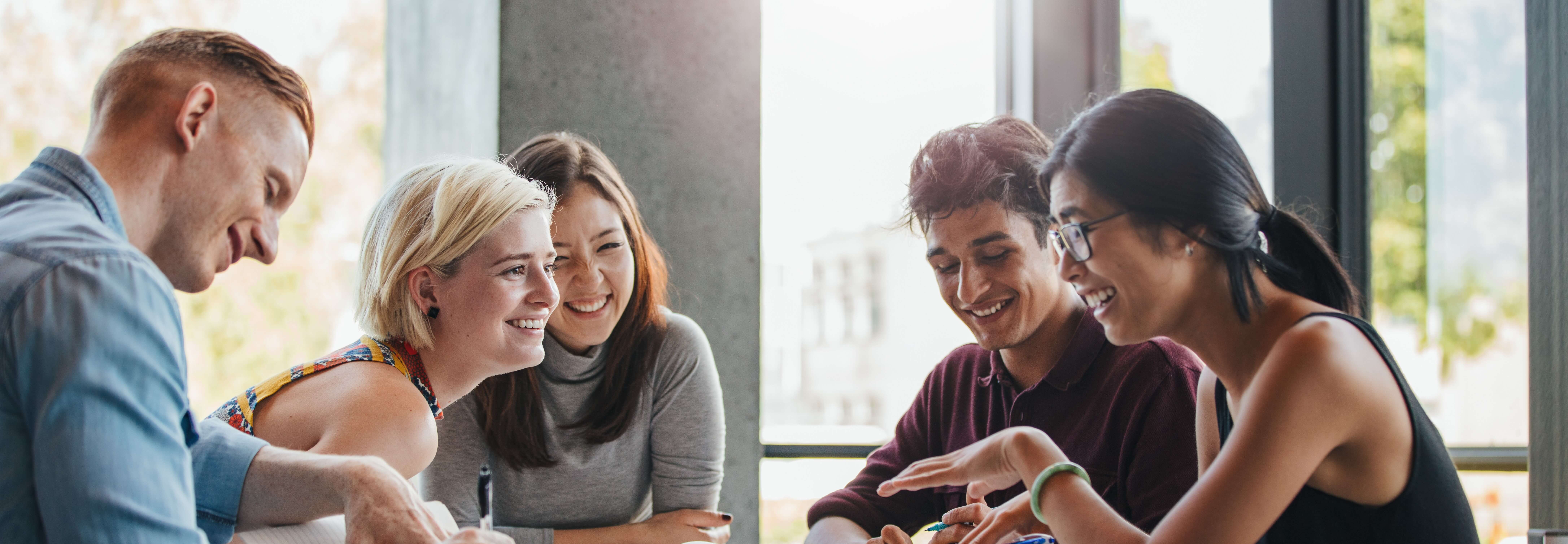Global_Programmes_Homepage_students_smiling_chatting_around_table-cropped