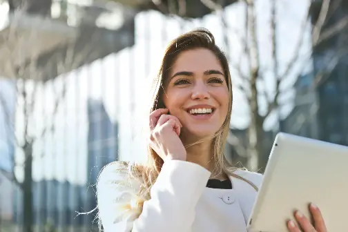 Global-Programmes-smiling-young-executive-on-phone-outside-glass-building