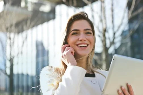 Global-Programmes-smiling-young-executive-on-phone-outside-glass-building
