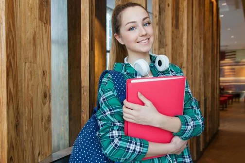 Global-Programmes-student-holding-folder-in-hallway