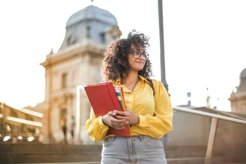 Global-Programmes-student-walk-down-steps-away-fromcampus-building
