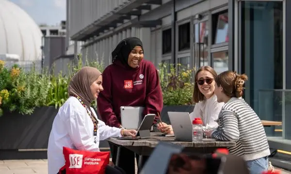 students smiling and chatting in the sunshine