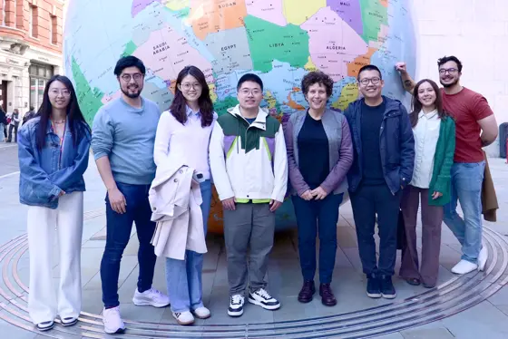The Psychometrics Lab team standing in front of the globe on the LSE campus