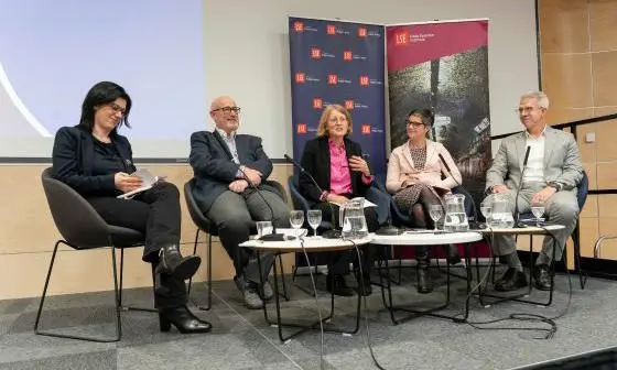 Panelists sit in a discussion