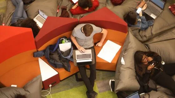 Overhead view of student seated on a sofa