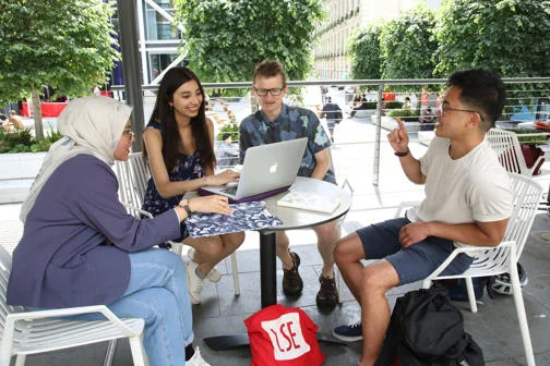 Research students around table on campus
