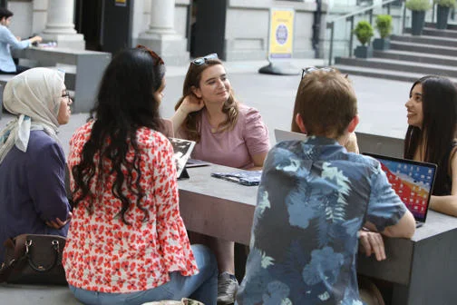A group of LSE PhD students outside the New Academic Building