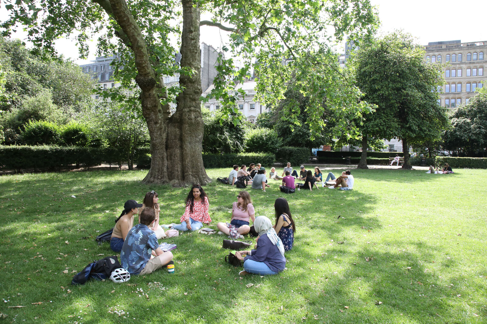Research students sitting in Lincoln's Inn Fields.