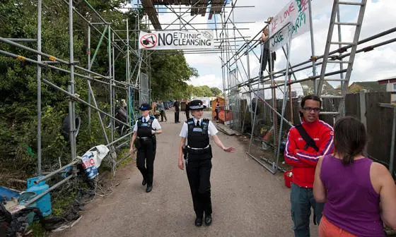 Police walk through Dale Farm.
