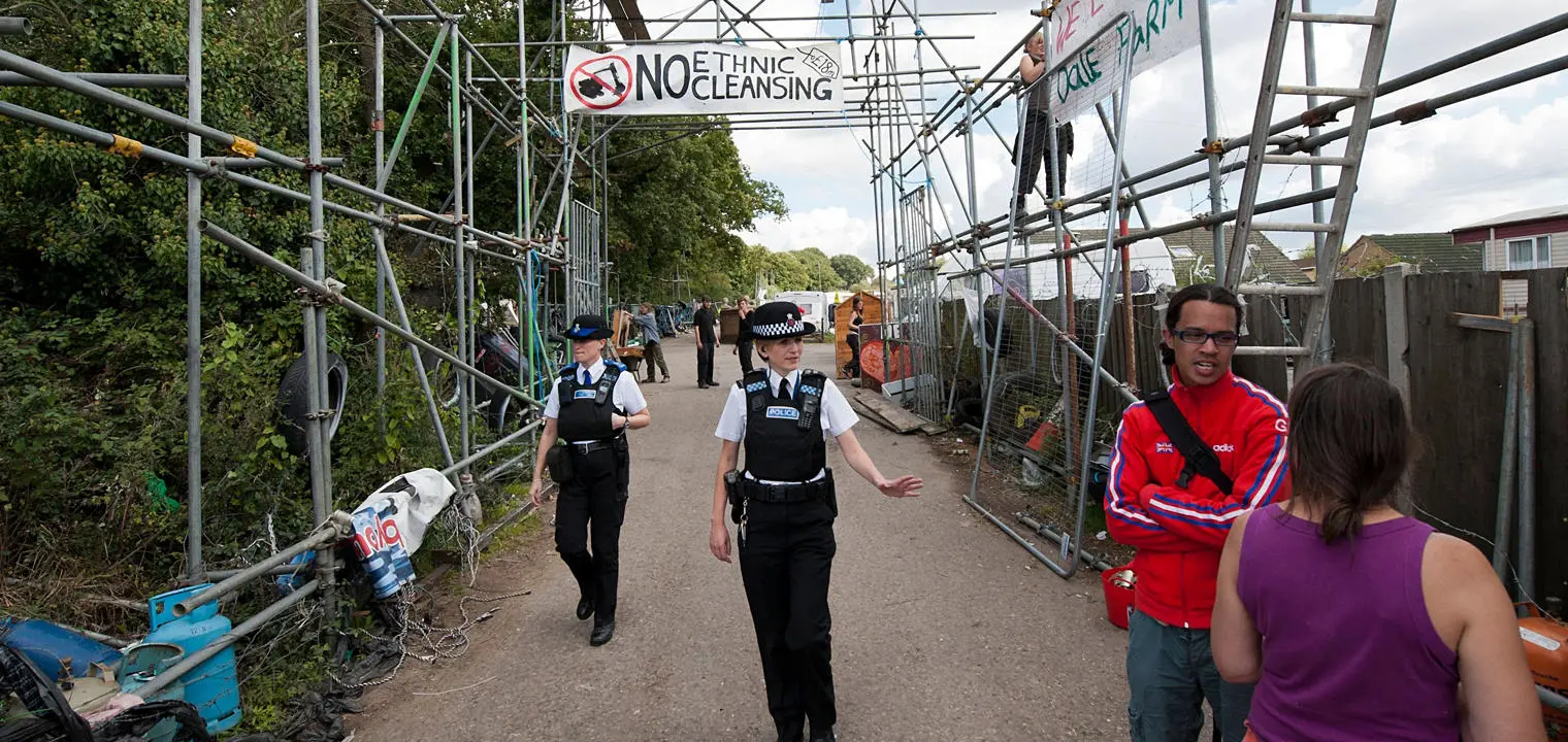 Police walk through Dale Farm.