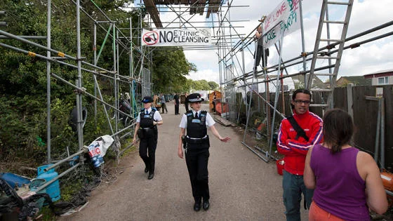 Police walk through Dale Farm.