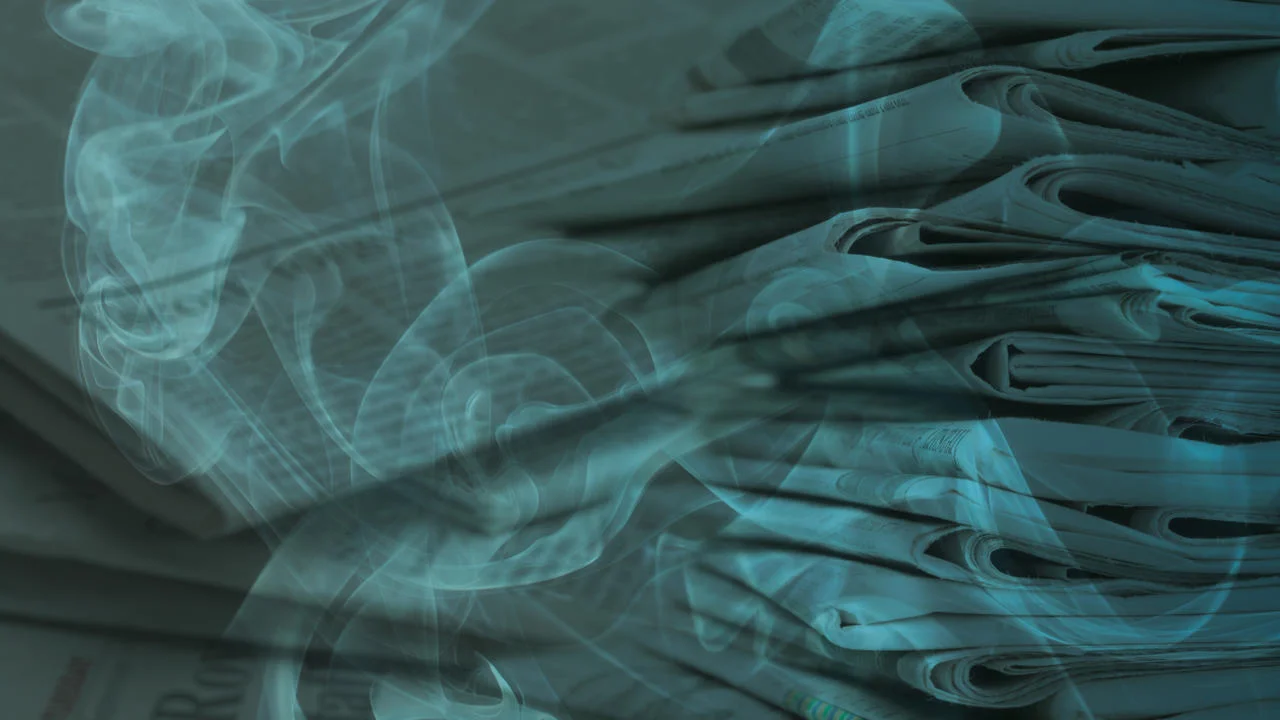 A pile of newspapers with smoke overlaid.