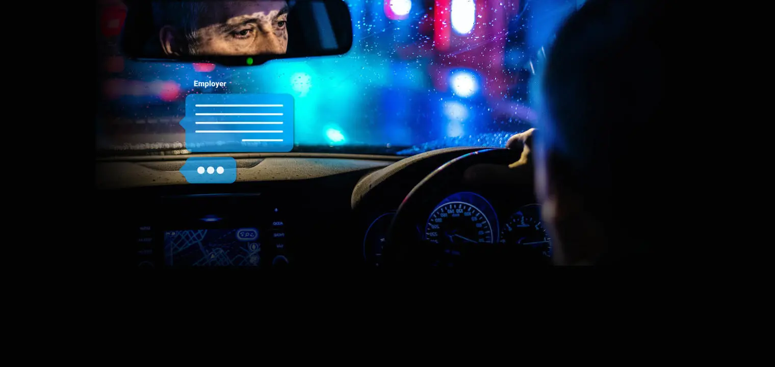 Reflection of a driver in the rearview mirror