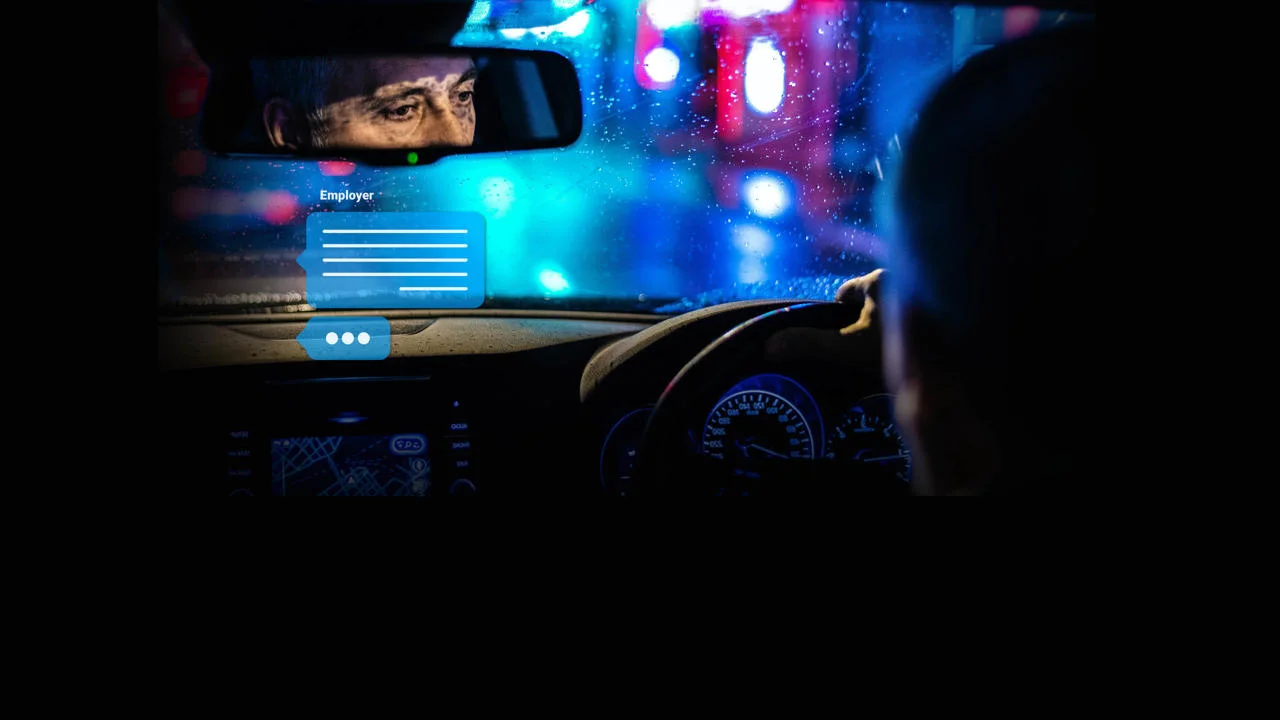 Reflection of a driver in the rearview mirror