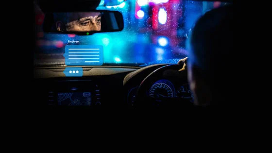 Reflection of a driver in the rearview mirror