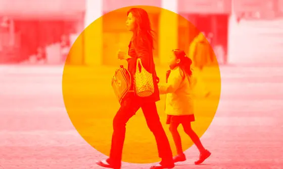 A woman holding a child's hand