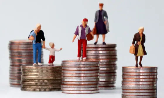 Figurines standing on stacks of coins