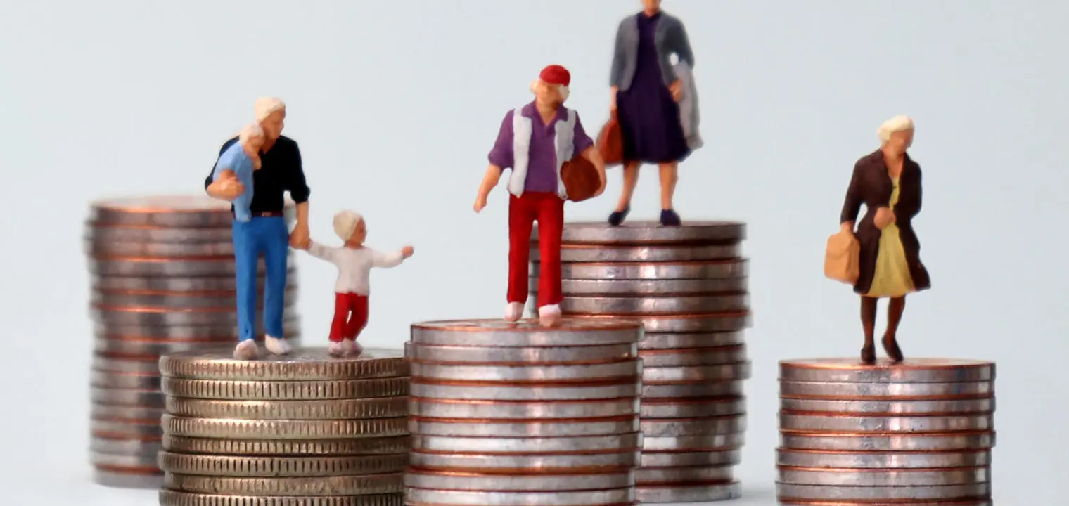Figurines standing on stacks of coins