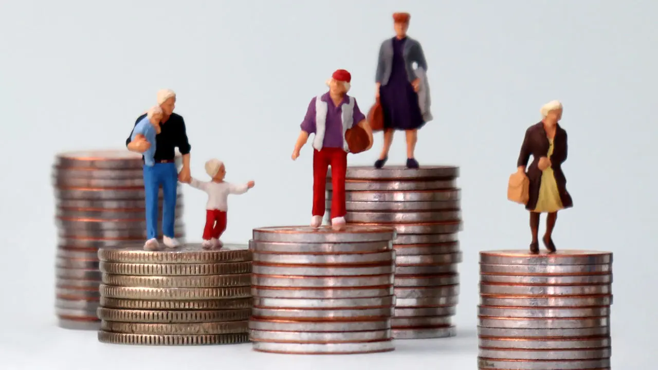 Figurines standing on stacks of coins