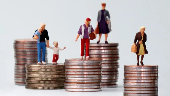 Figurines standing on stacks of coins