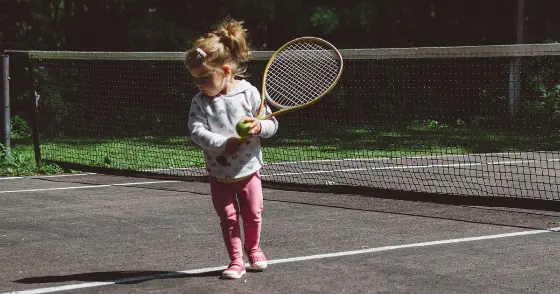A child holding a tennis racquet