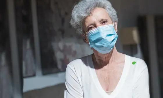 A person wears a face mask at a care home