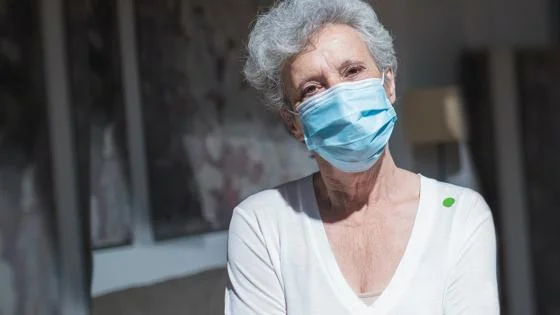 A person wears a face mask at a care home