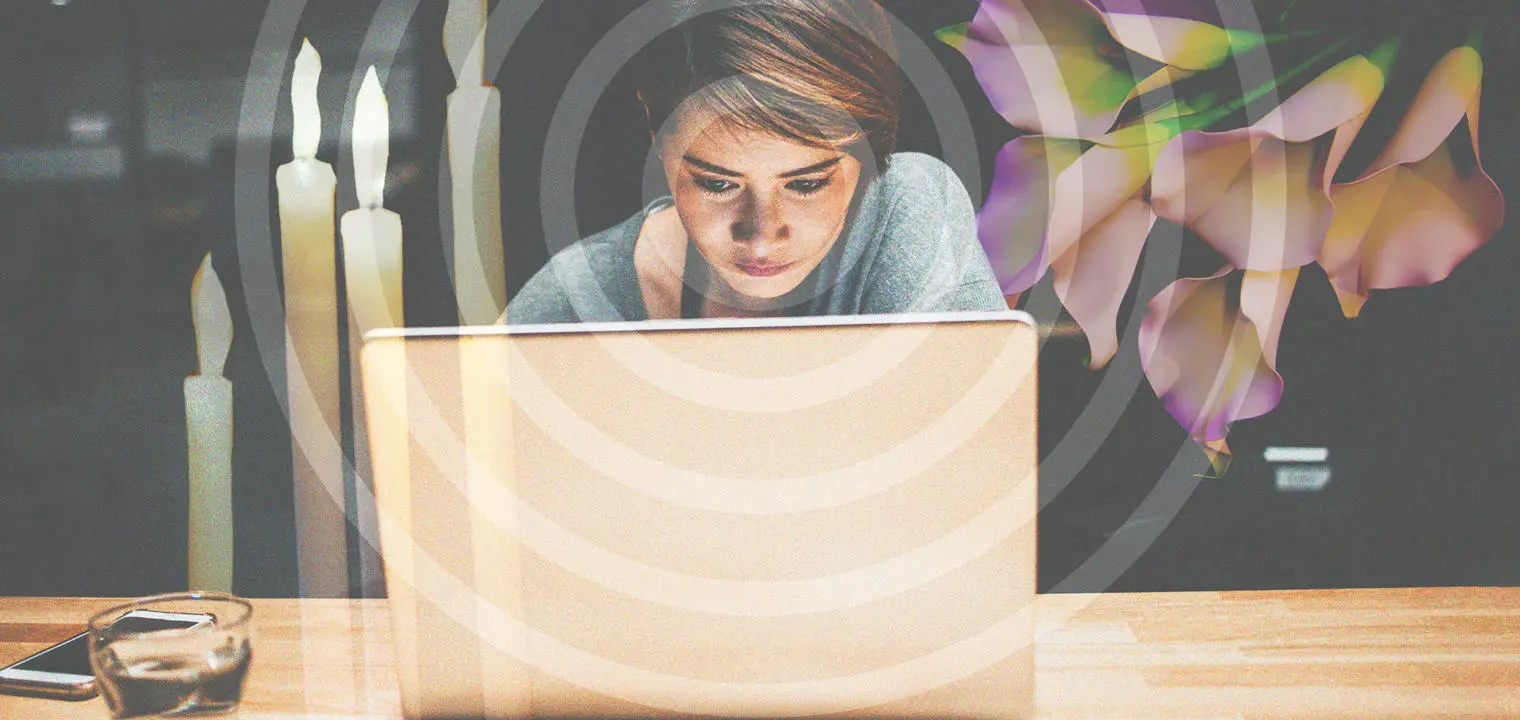 A woman looking at a laptop