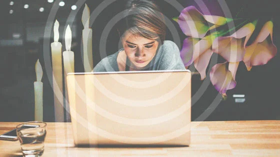 A woman looking at a laptop