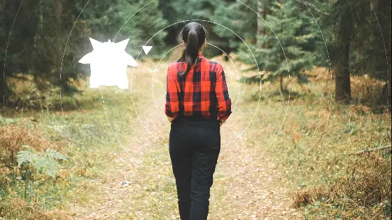 woman playing a smartphone location game in a park
