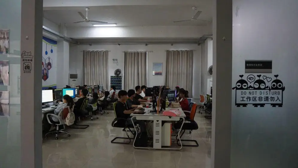 Students at computers in a workshop