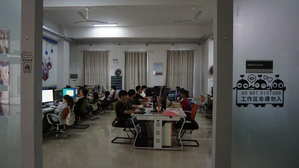 Students at computers in a workshop