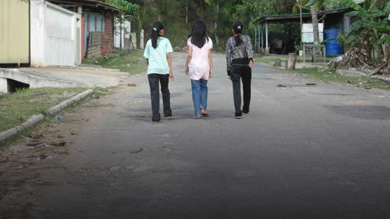 Girls walking on a road in East Malaysia
