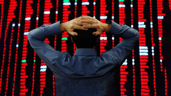 man looking at financial board