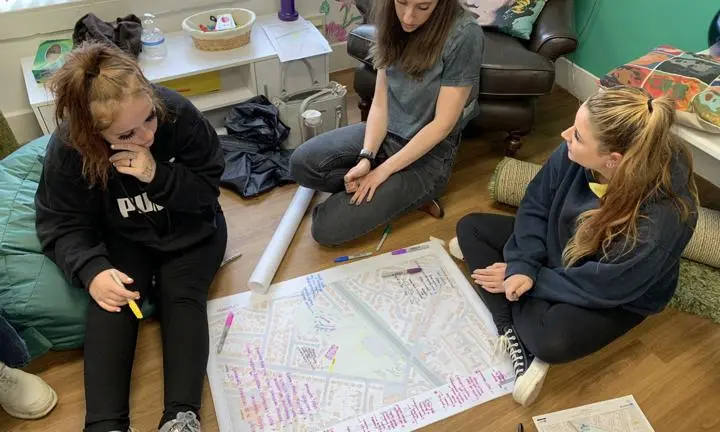 Three researchers-in-residence discussing and mapping what better, more inclusive, public spaces might be like in Crewe.