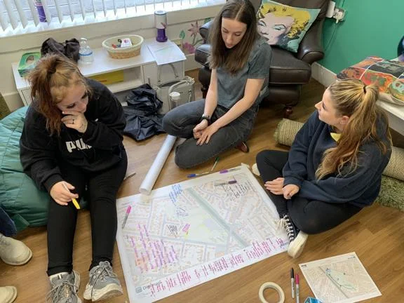 Three researchers-in-residence discussing and mapping what better, more inclusive, public spaces might be like in Crewe.