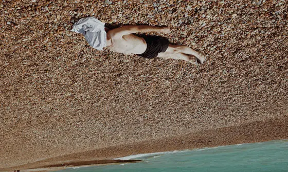 man lying on the beach sunbathing