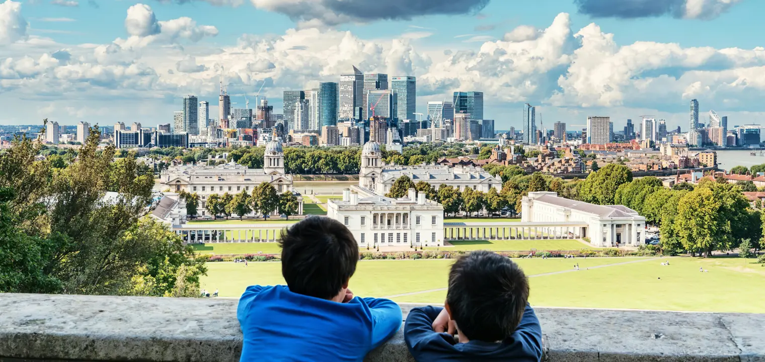 Two boys looking at park with a view of the city