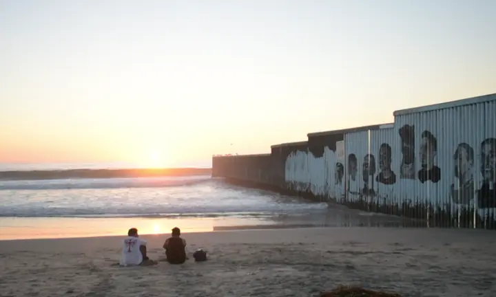 Two men watch the sunset in Playas de Tijuana