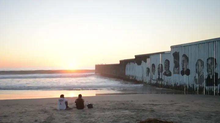 Two men watch the sunset in Playas de Tijuana