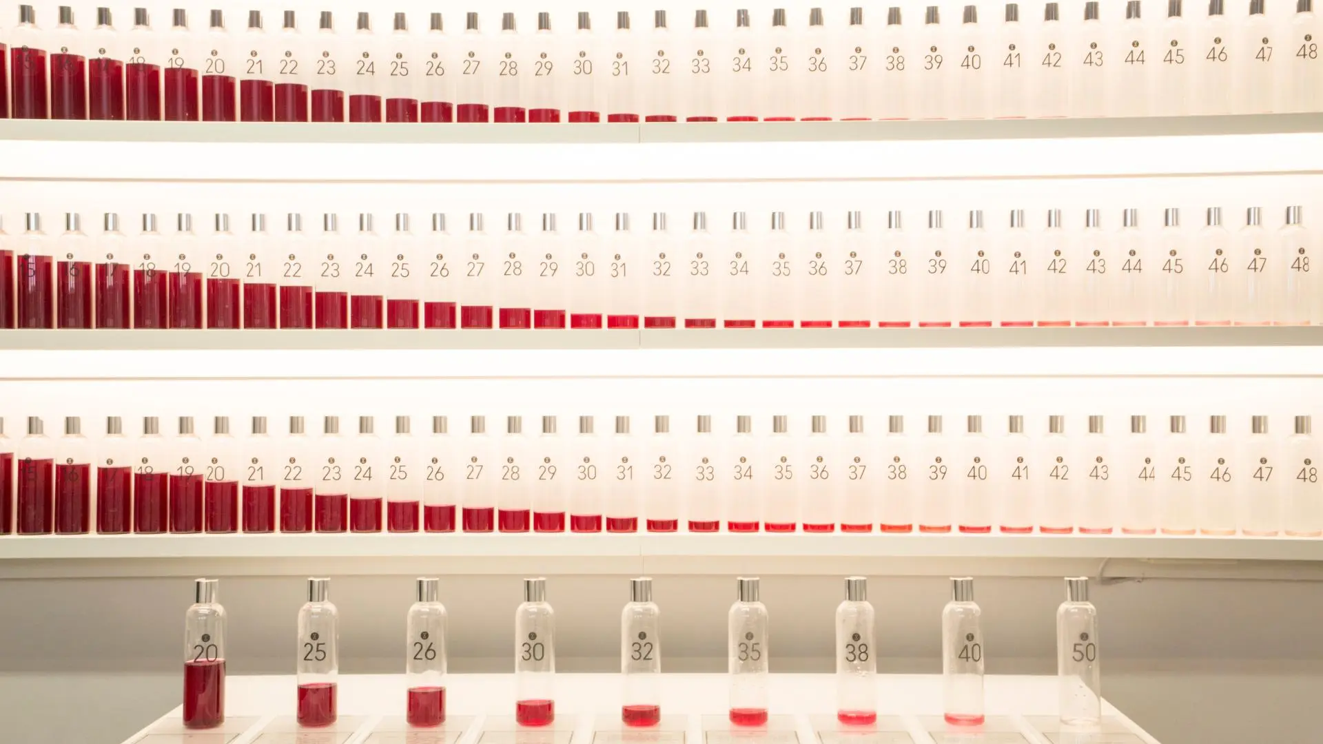 Test tube display representing the number of eggs a woman would have in her ovaries according to age.